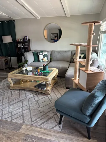 a living room with furniture a window and gym equipment