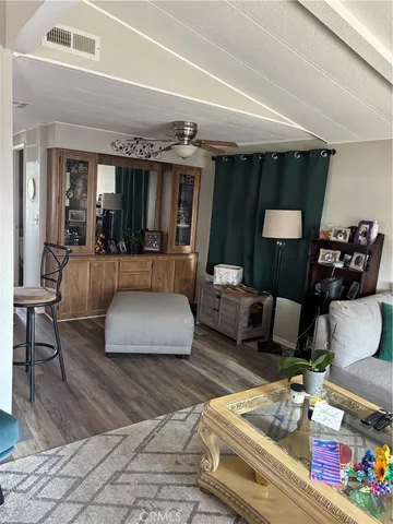 a living room with furniture a window and gym equipment