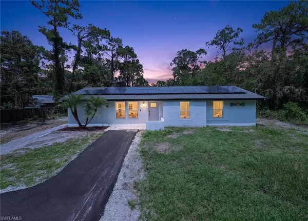 a view of a house with backyard