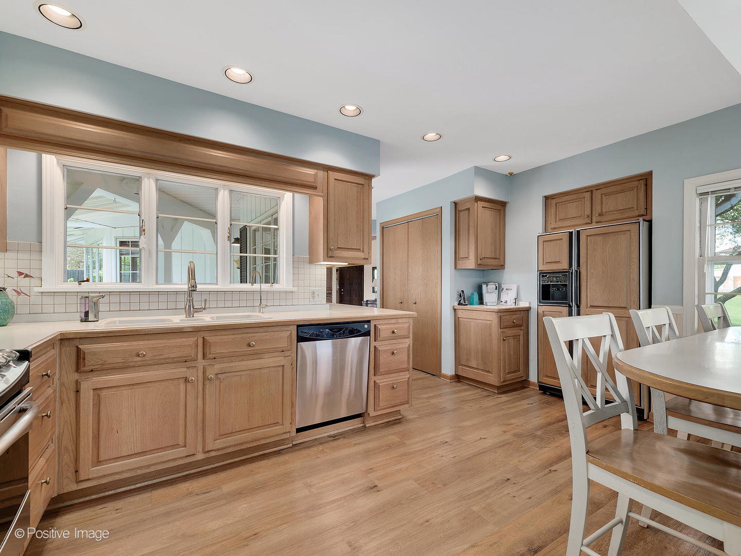 6401 South County Line Road Burr Ridge, IL 60527 - Photo 17 of 57 a large kitchen with kitchen island granite countertop a large window and white cabinets