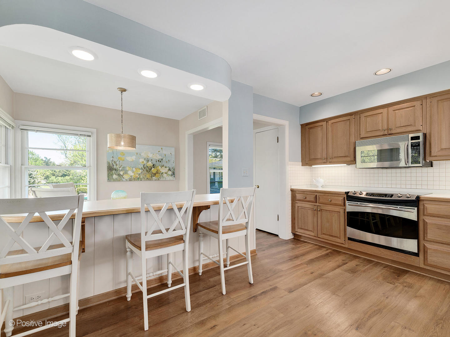 6401 South County Line Road Burr Ridge, IL 60527 - Photo 19 of 57 a kitchen with stainless steel appliances granite countertop a stove top oven a sink dishwasher a dining table and chairs with wooden floor