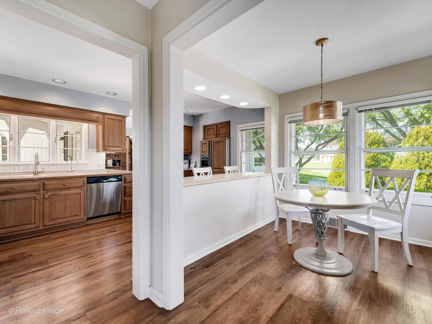 6401 South County Line Road Burr Ridge, IL 60527 - Photo 27 of 57 a kitchen with a large window wooden floor and stainless steel appliances