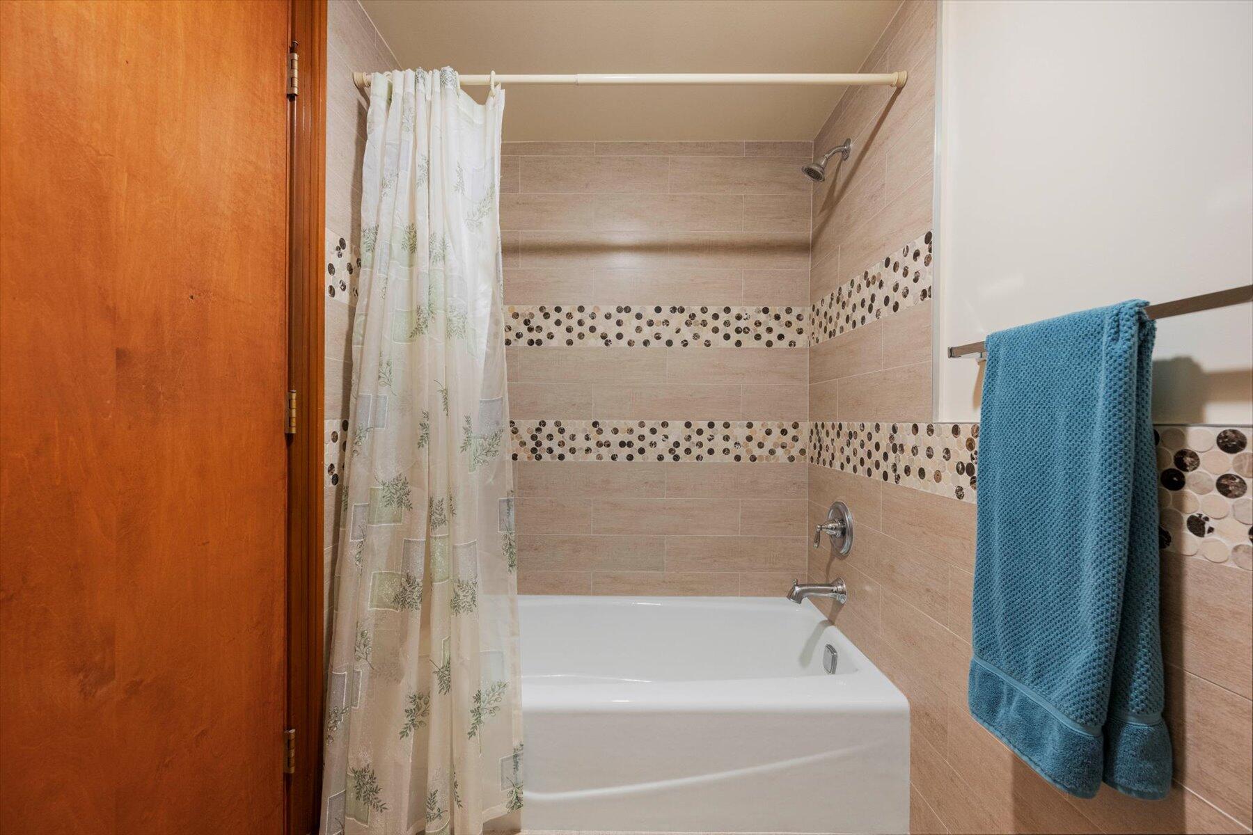 13244 Polo Club Road, Unit C207 Wellington, FL 33414 - Photo 16 of 31 a bathroom with a bathtub and a shower