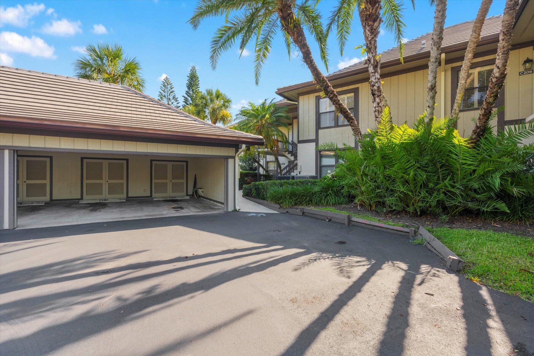 13244 Polo Club Road, Unit C207 Wellington, FL 33414 - Photo 23 of 31 a front view of a house with garden