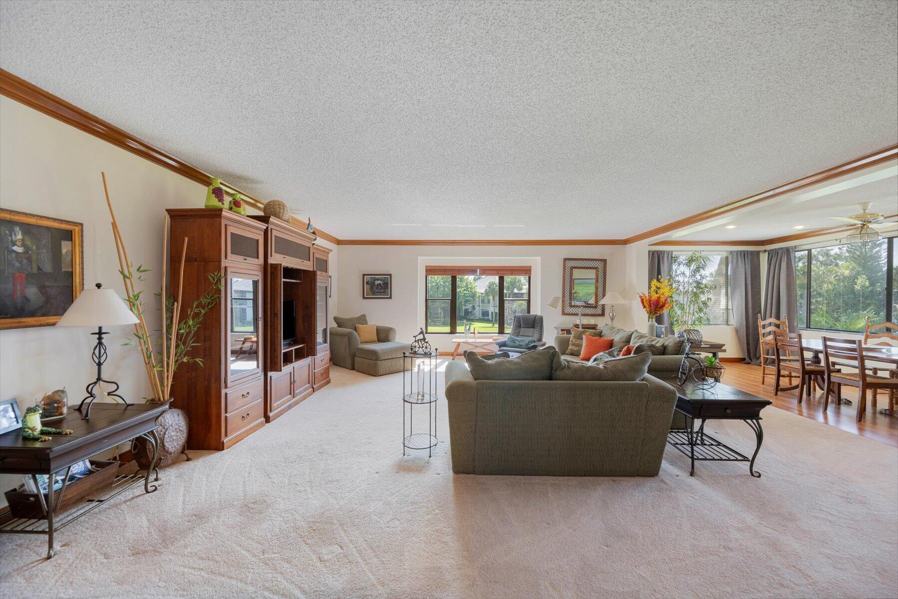 13244 Polo Club Road, Unit C207 Wellington, FL 33414 - Photo 25 of 31 a living room with furniture and a flat screen tv