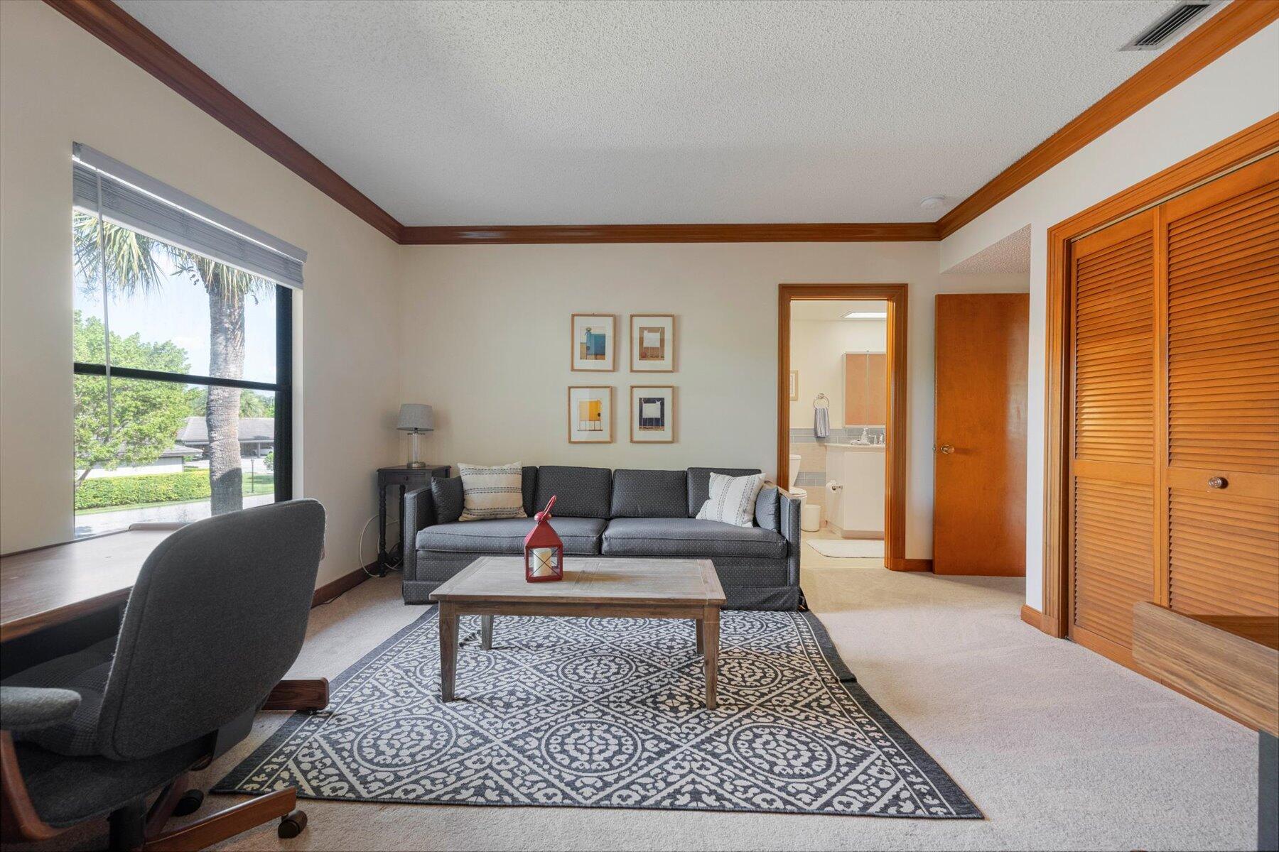 13244 Polo Club Road, Unit C207 Wellington, FL 33414 - Photo 26 of 31 a living room with furniture a rug a window and a rug