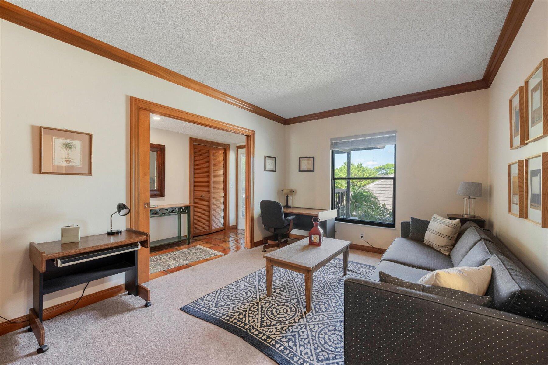 13244 Polo Club Road, Unit C207 Wellington, FL 33414 - Photo 27 of 31 a living room with furniture a rug and a window