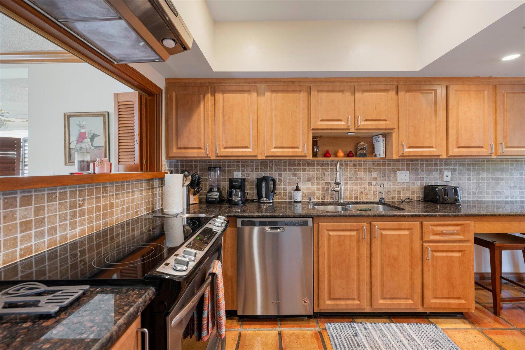 13244 Polo Club Road, Unit C207 Wellington, FL 33414 - Photo 6 of 31 a kitchen with stainless steel appliances a stove sink and cabinets