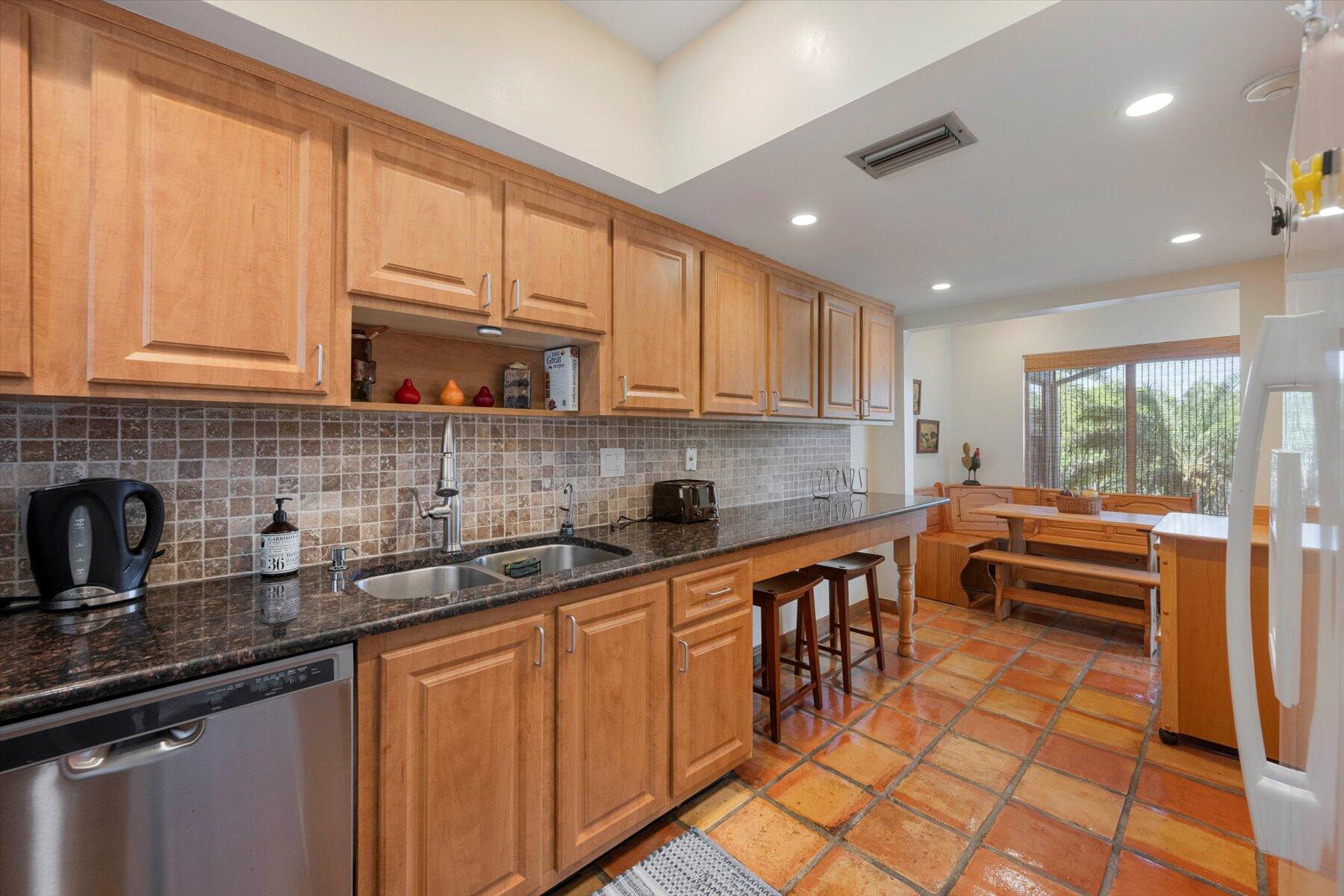13244 Polo Club Road, Unit C207 Wellington, FL 33414 - Photo 7 of 31 a kitchen with stainless steel appliances granite countertop a sink and cabinets