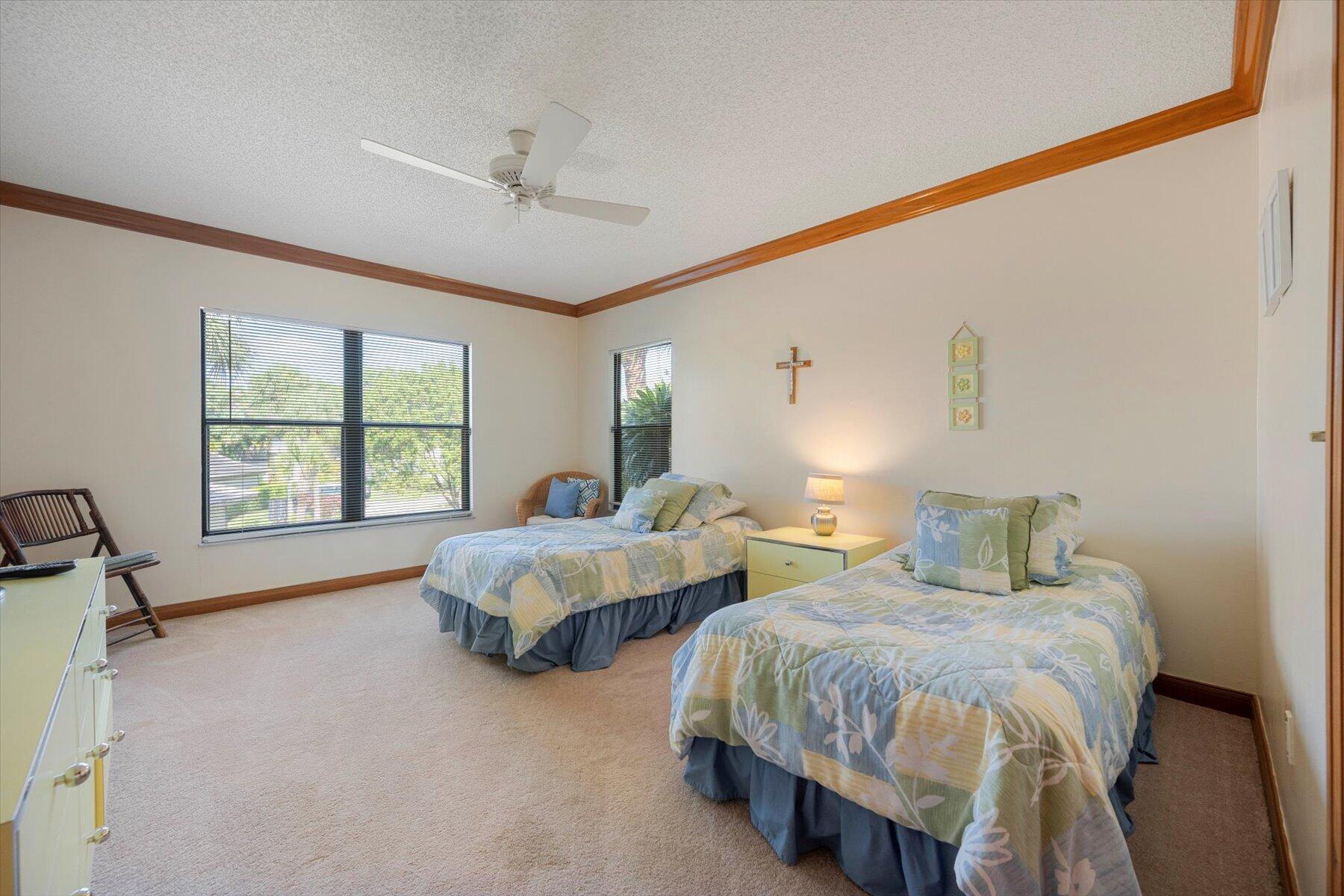 13244 Polo Club Road, Unit C207 Wellington, FL 33414 - Photo 9 of 31 a spacious bedroom with two beds and a window