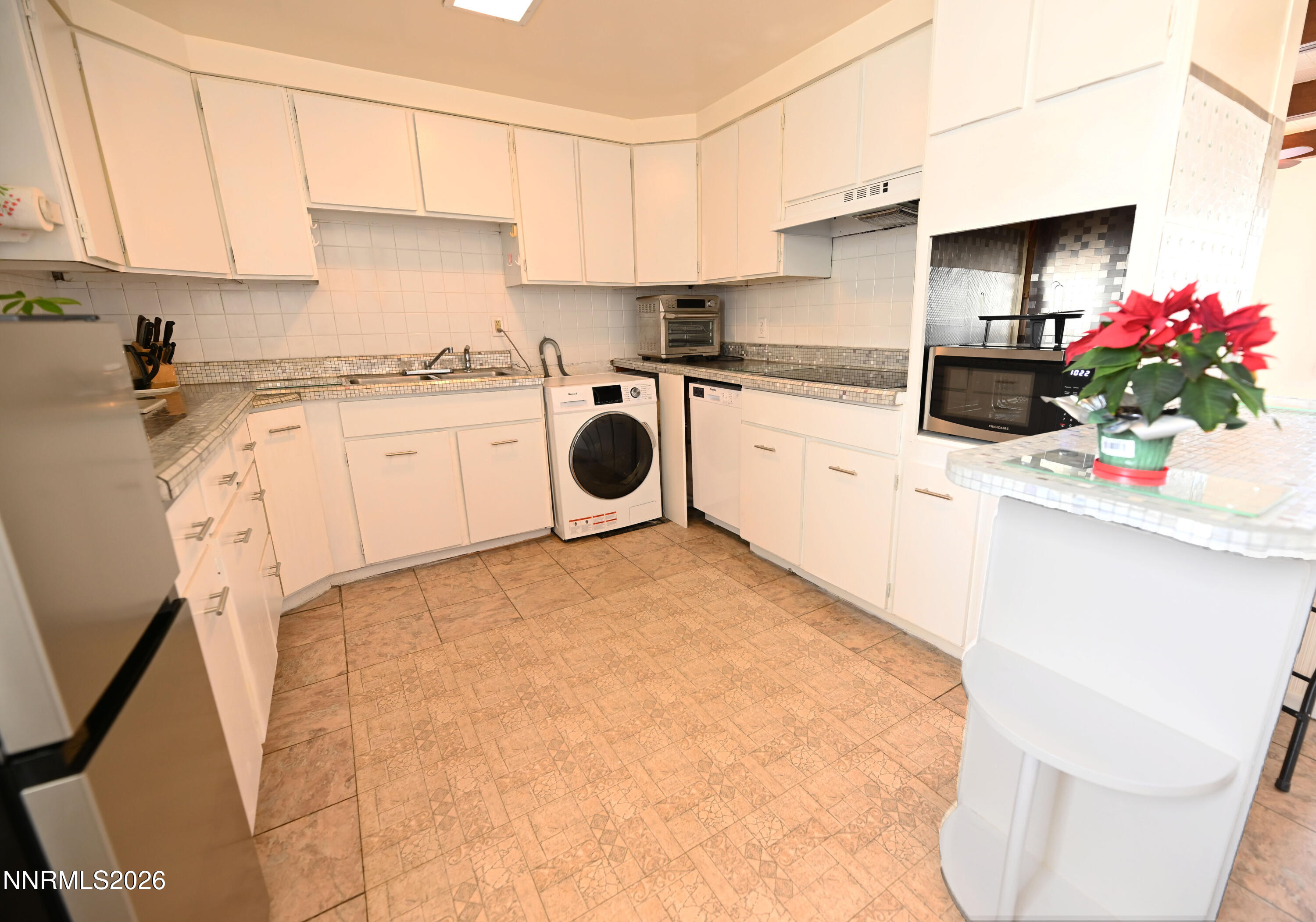 110 Harrison Street Hawthorne, NV 89415 - Photo 13 of 30 a kitchen with a white cabinets and white appliances