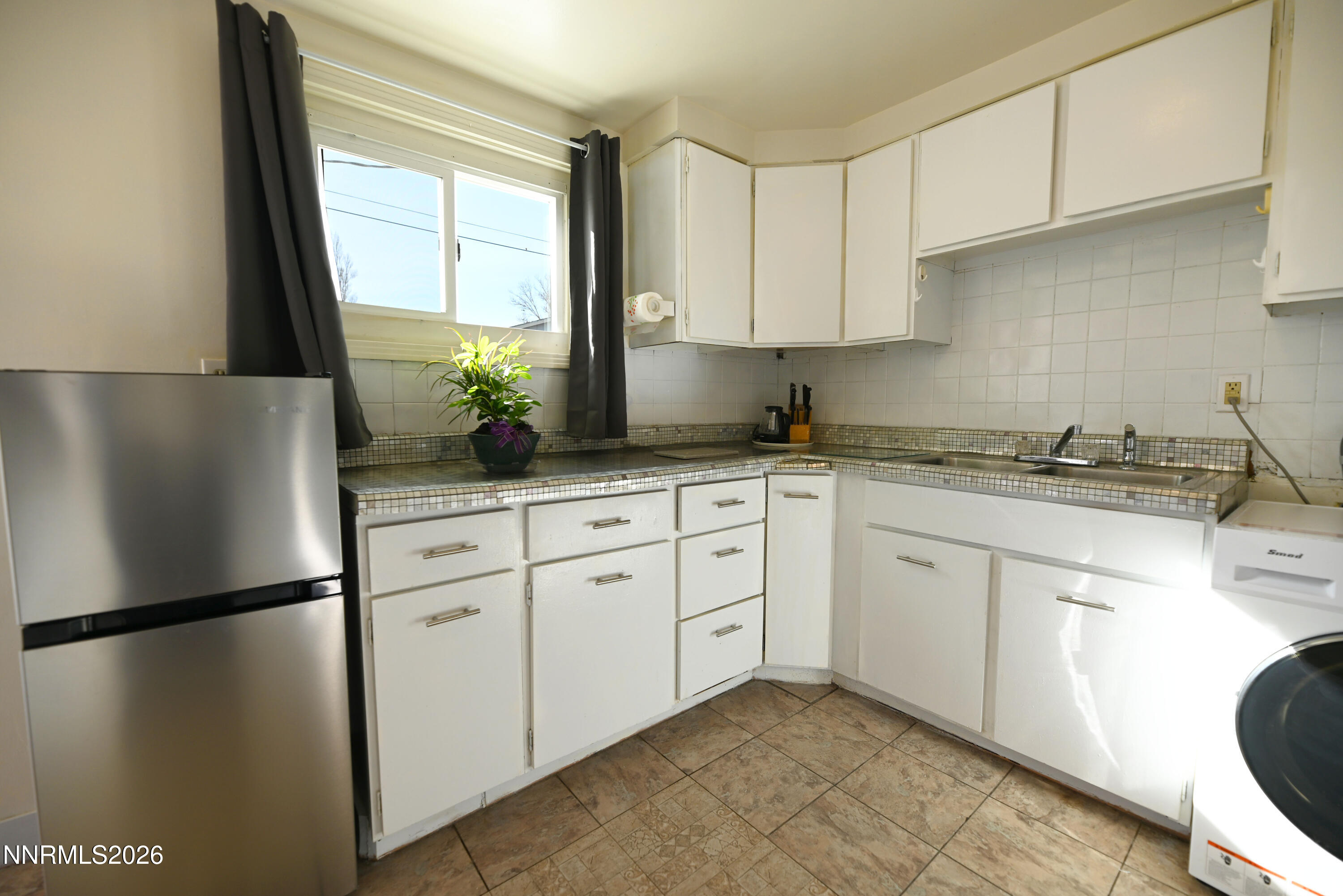 110 Harrison Street Hawthorne, NV 89415 - Photo 14 of 30 a kitchen with a refrigerator sink and cabinets