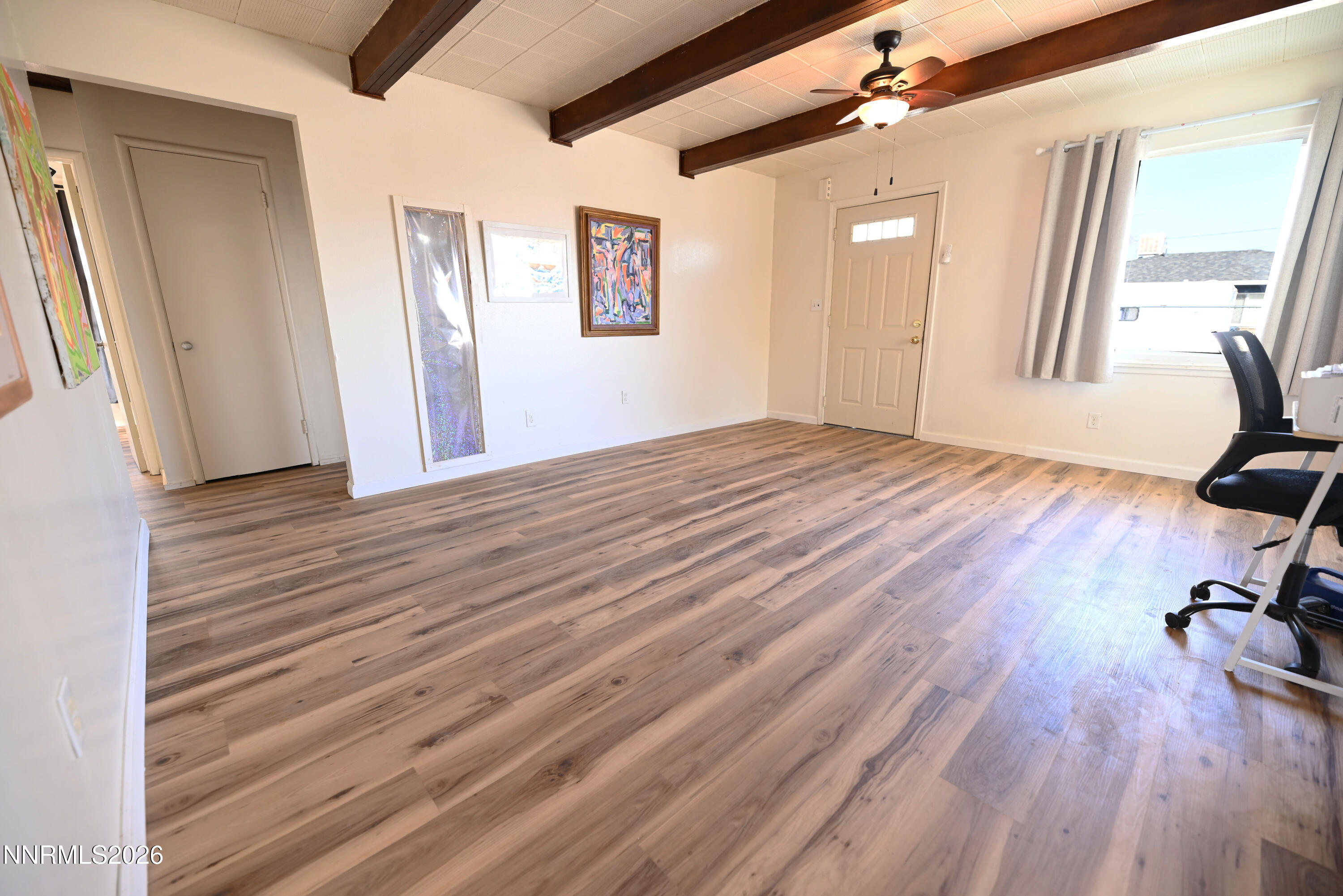 110 Harrison Street Hawthorne, NV 89415 - Photo 7 of 30 a view of empty room with wooden floor and fan
