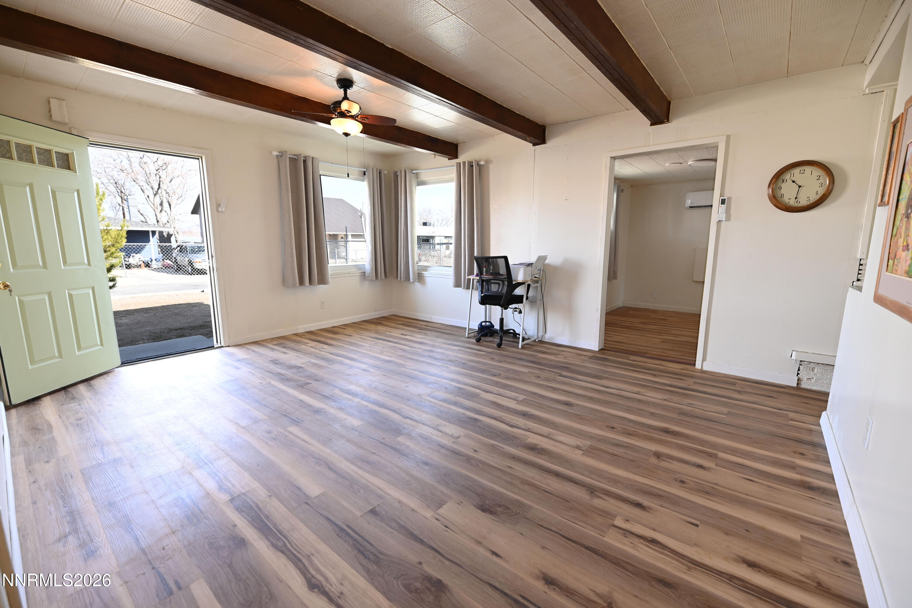 110 Harrison Street Hawthorne, NV 89415 - Photo 8 of 30 a view of an empty room with wooden floor and a window