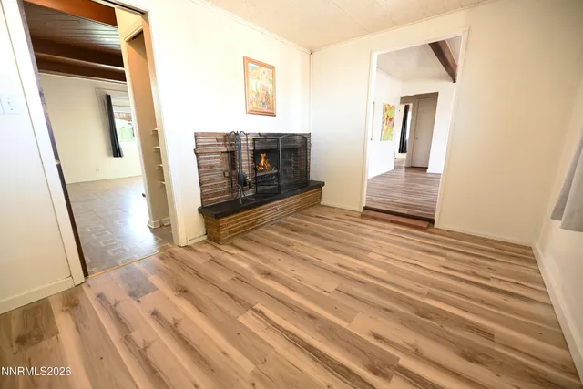 a view of a livingroom with wooden floor and staircase
