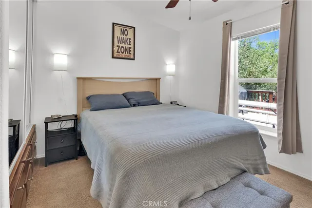 a bedroom with a bed and a large window