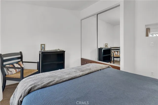 a bedroom with a bed and dresser