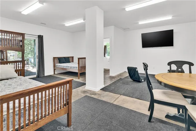 a bedroom with furniture and a flat screen tv