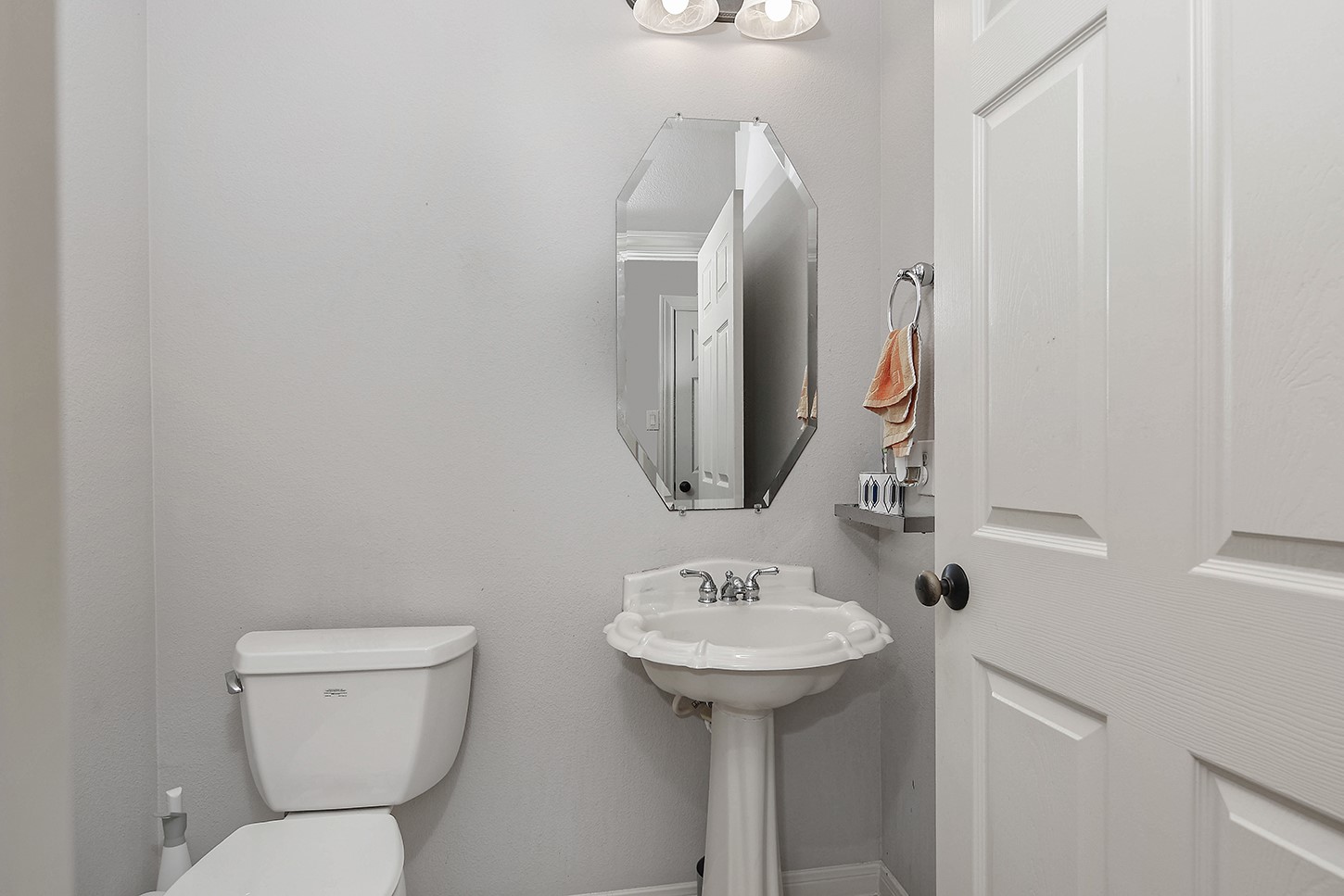 18722 Duke Lake Drive Spring, TX 77388 - Photo 6 of 26 a bathroom with a toilet sink and mirror