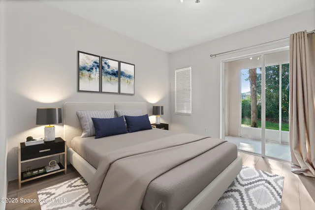 a bedroom with a bed and a large window