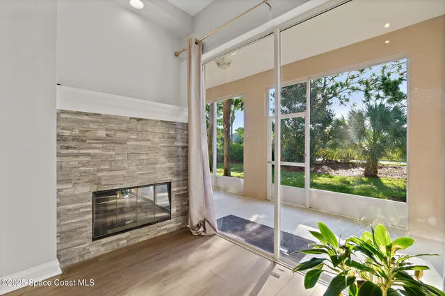 a living room with a fireplace furniture and a potted plant