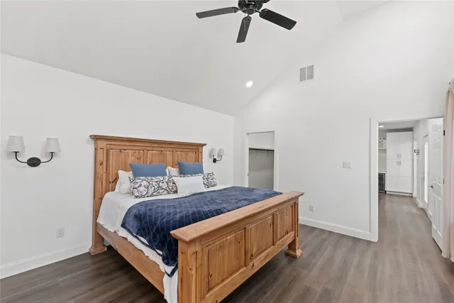 a bedroom with a bed and ceiling fan