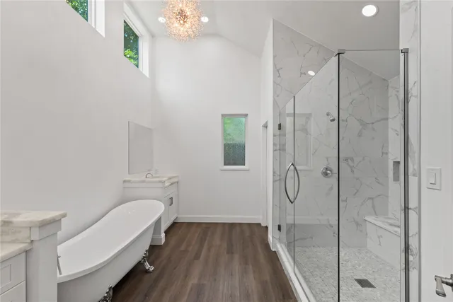 a bathroom with a shower a toilet and sink