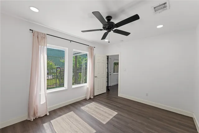a view of a livingroom with a ceiling fan and window