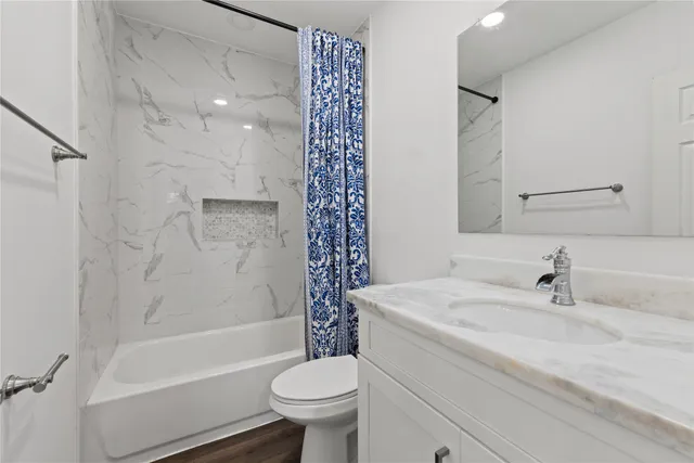 a bathroom with a sink toilet and shower