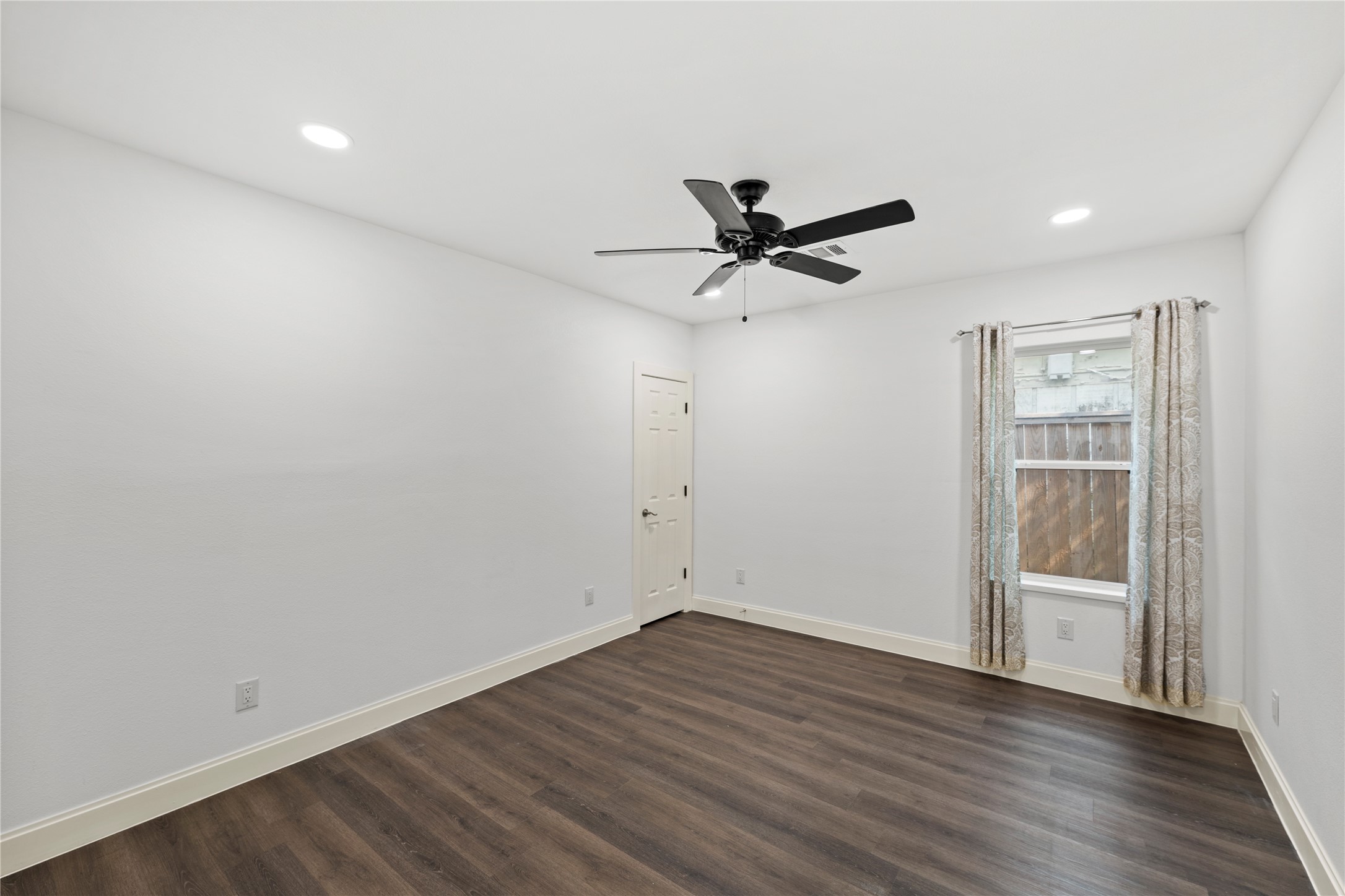 3211 Cochran Street Houston, TX 77009 - Photo 20 of 32 an empty room with wooden floor and windows