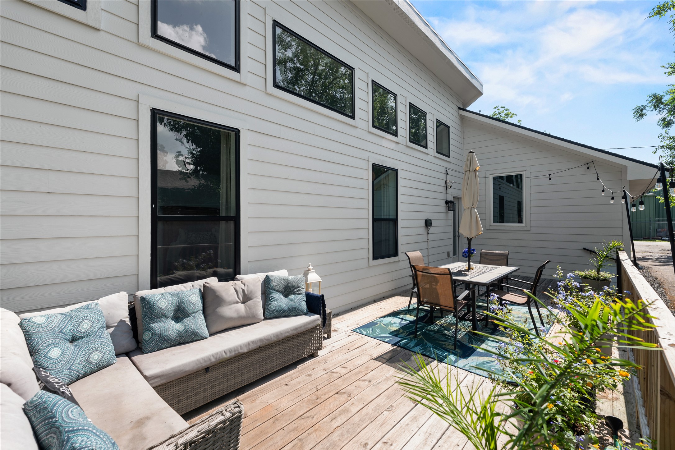 3211 Cochran Street Houston, TX 77009 - Photo 22 of 32 a view of a patio with couches and a table and chairs with wooden floor
