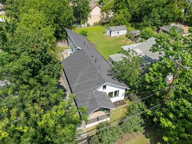 an aerial view of a house with outdoor space