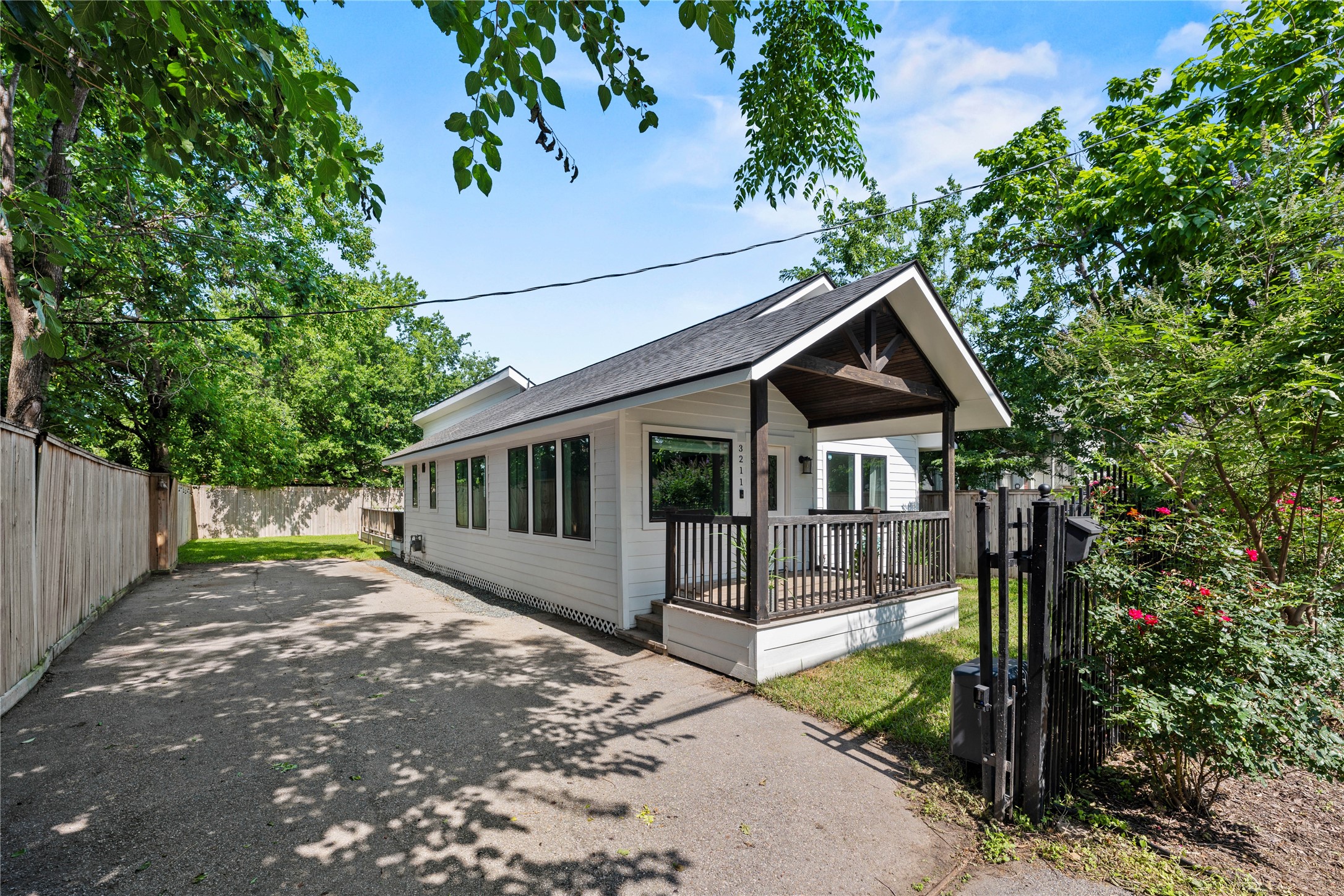 3211 Cochran Street Houston, TX 77009 - Photo 31 of 32 a front view of a house with a yard table and chairs