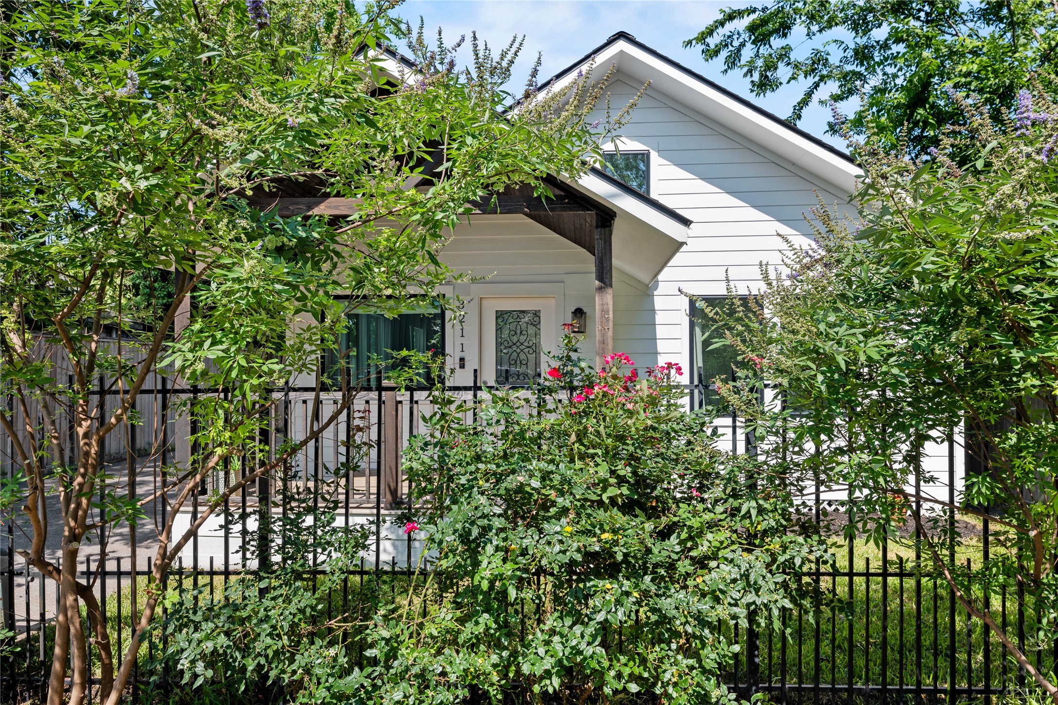 3211 Cochran Street Houston, TX 77009 - Photo 32 of 32 a small yard with a white roof and potted plants