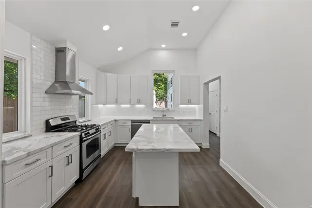 a kitchen with a stove a sink and a refrigerator