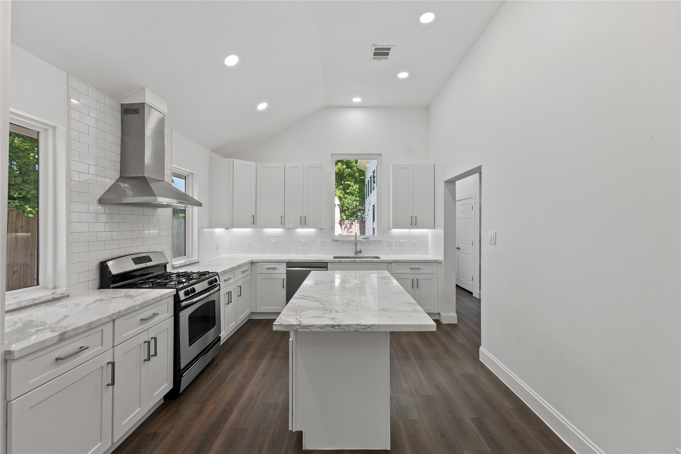 3211 Cochran Street Houston, TX 77009 - Photo 5 of 32 a kitchen with a stove a sink and a refrigerator