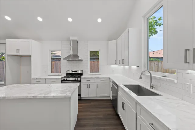 a kitchen with a sink stove top oven and refrigerator