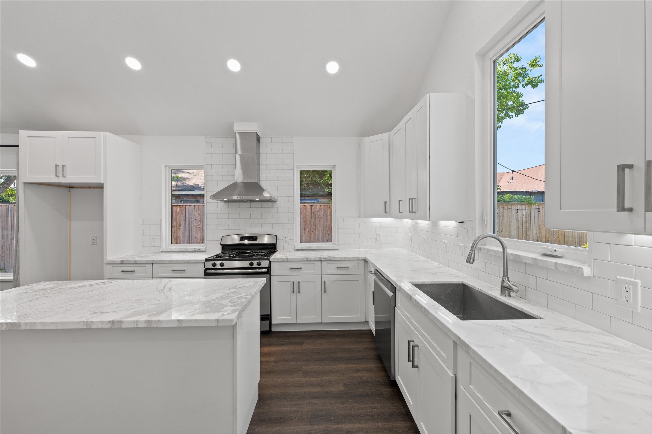 3211 Cochran Street Houston, TX 77009 - Photo 6 of 32 a kitchen with a sink stove top oven and refrigerator