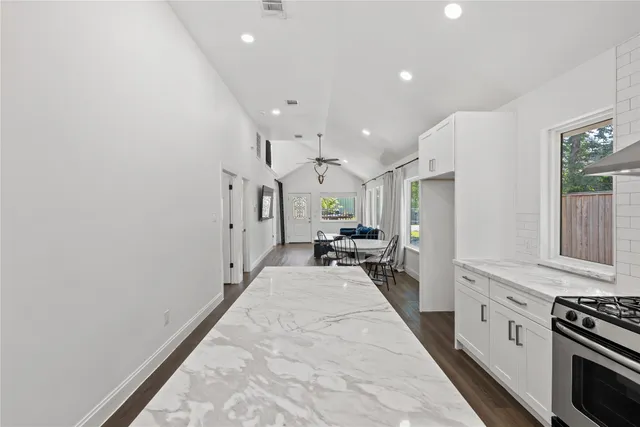 a kitchen with sink cabinets and stainless steel appliances