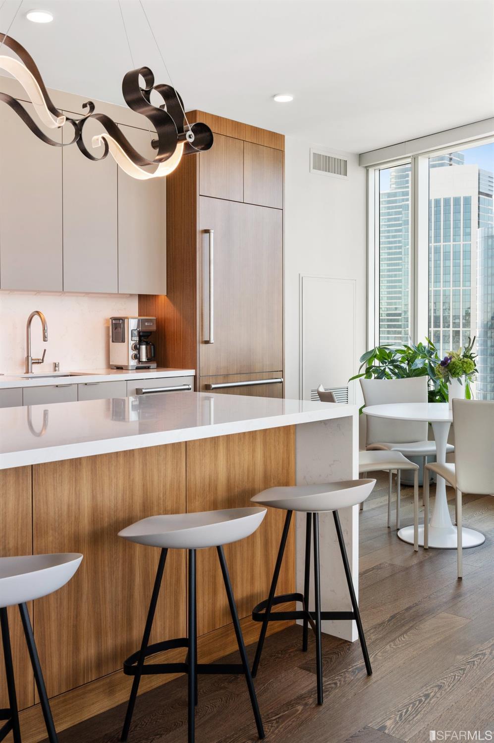 338 Spear Street, Unit 39E San Francisco, CA 94105 - Photo 18 of 97 a kitchen with a table chairs sink and cabinets