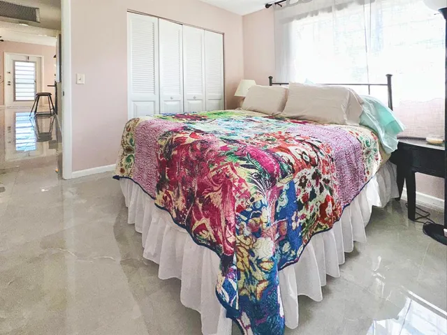 a bed sitting in a bedroom next to a window