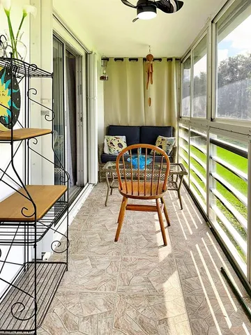 a view of a chairs and table in the balcony