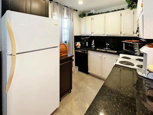 a white refrigerator freezer sitting in a kitchen