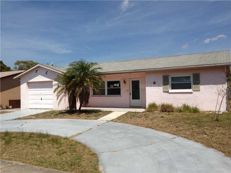 7427 Cay Drive Port Richey, FL 34668 - Photo 1 of 1 a house with palm tree in front of it