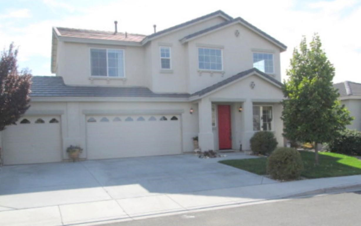 2560 Perryville Drive Reno, NV 89521 - Photo 1 of 1 a front view of a house with a yard and garage