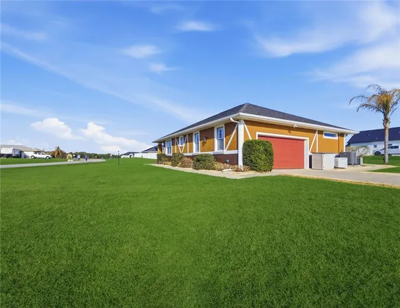 a view of an house with backyard space and garden