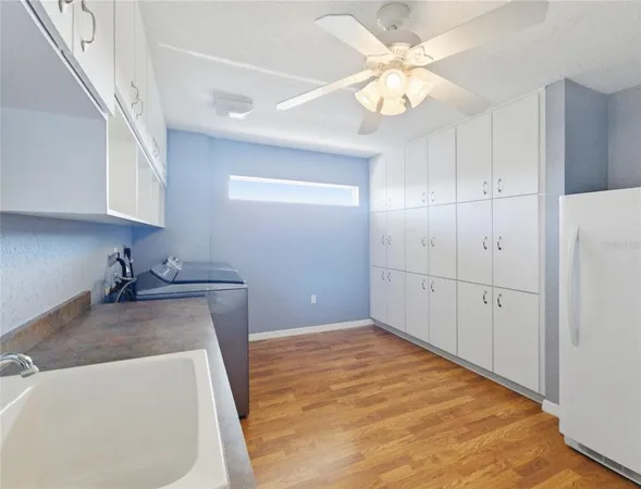 a kitchen with granite countertop cabinets stainless steel appliances and a wooden floor