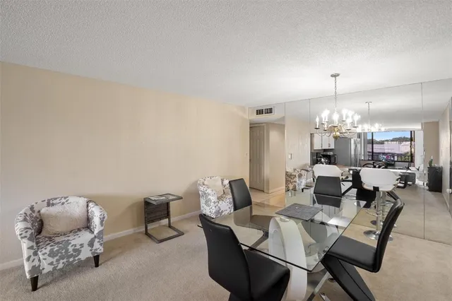 a dining room with furniture and chandelier