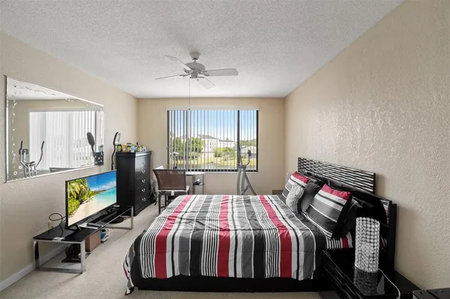 a bed sitting in a bedroom next to a window