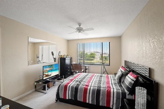 a bed room with a bed and a tv